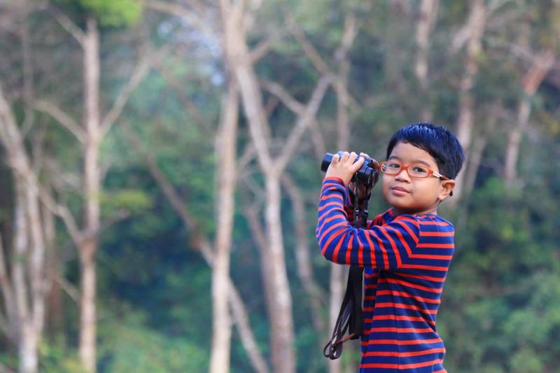 Young boy bird watching